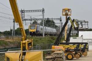 A stock photo of a Northern rail passenger train passing through engineering work on the York : Leeds rail line in northern England
