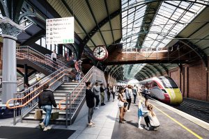 A visualisation of the inside of the station showing a staircase leading to a footbridge up in the roof and a train waiting on the platform